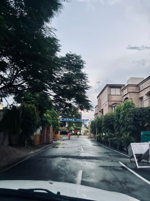 A rain-washed street under heavy monsoon sky