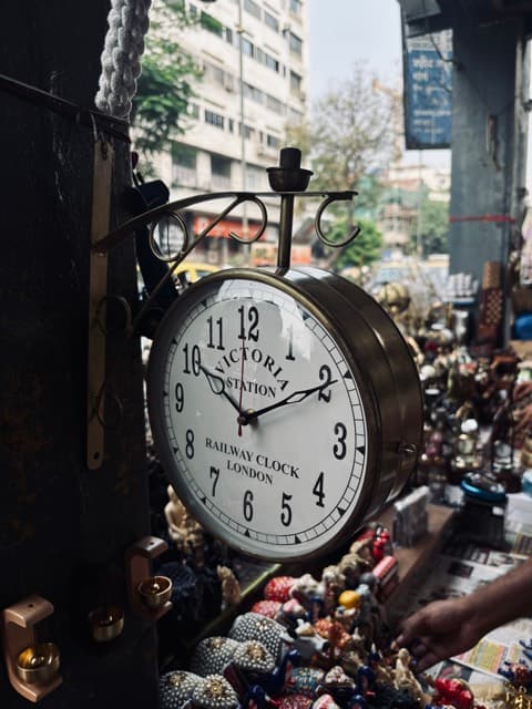 Antique Victoria station railway clock at a Mumbai bazaar