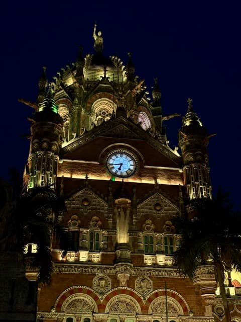 Chhatrapati Shivaji Terminus lit gold against the night sky