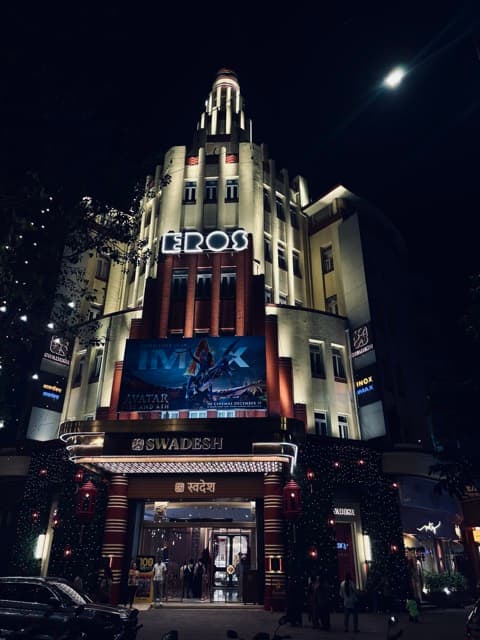 Art-deco Eros cinema glowing at night